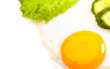 fried egg with fresh vegetables on white backgroundの写真素材