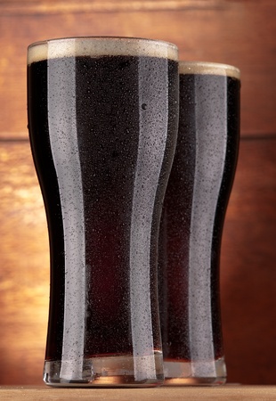 glasses of fresh dark beerの写真素材