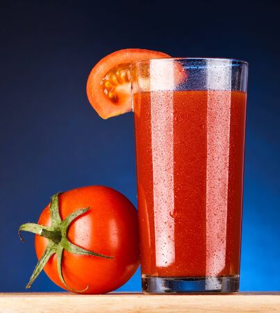 wet glass of tomato juiceの写真素材