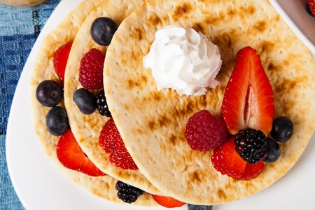 pancakes with fresh ripe berries and whipped creamの写真素材