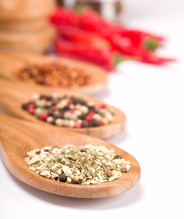 lot of spices in wooden spoons isolated on white backgroundの写真素材