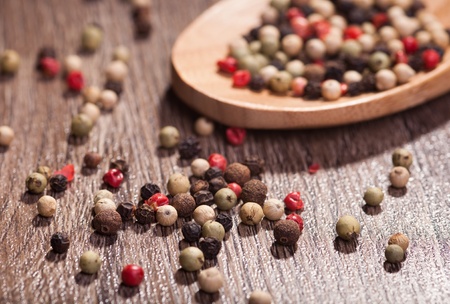 colorful pepper in wooden spoonの写真素材