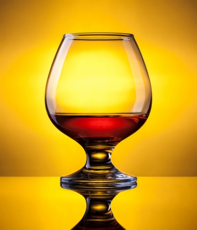 cognac in fancy glass, with reflectionの写真素材