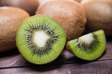 Ripe kiwi on wooden table close-upの写真素材