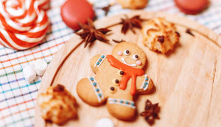 colorful Christmas sweets and hot drinks on the holiday table near the Christmas treeの写真素材