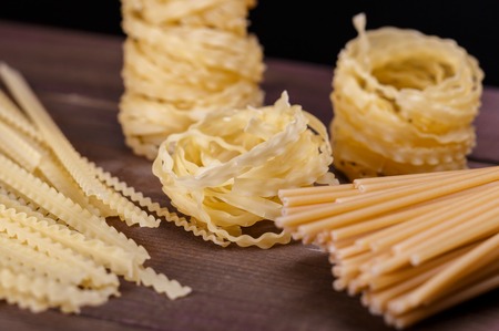 pasta with white wine on a wooden tableの写真素材
