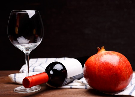 ripe pomegranate on a plade fabric on a wooden tableの写真素材