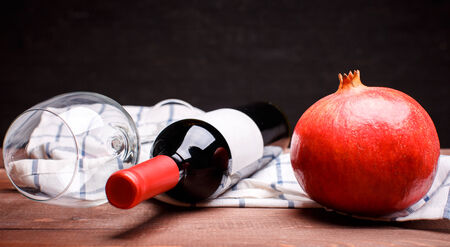 ripe pomegranate on a plade fabric on a wooden tableの写真素材