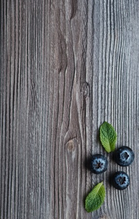 ripe blackberry with leaves of mint on a wooden backgroundの写真素材