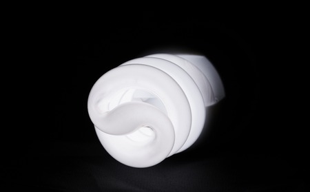 lighted energy saving lamp on a dark backgroundの写真素材