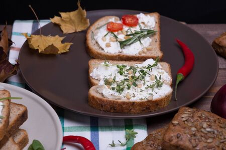 Sandwich with soft cheese and spinach surrounded composition of quail eggs red pepper and walnutsの写真素材