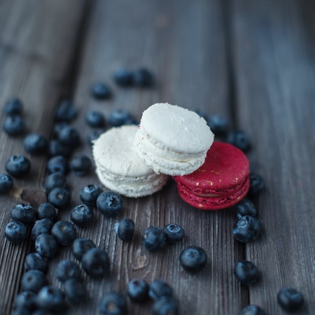 fresh macaroons and ripe blackberry on a wooden backgroundの写真素材
