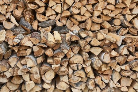 Pile of chopped birch firewood in remote Russian village. Woodpile, logger, sawn trees, background, texture wood.の写真素材