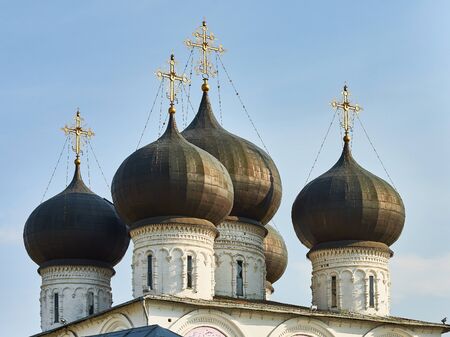 Domes and golden crosses of Orthodox Church against blue sky.の写真素材