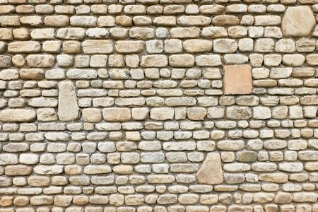 Texture of old brown stone wall for background built linearly and regularly.の写真素材