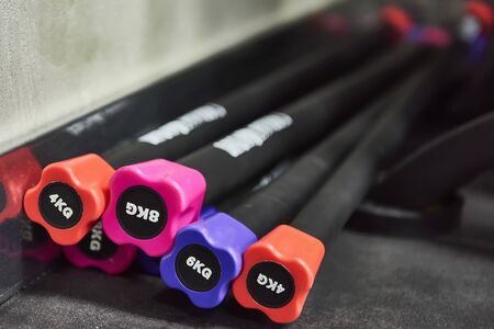 Fitness equipment for workout. Set of sport body bars for fitness in gym. Steel weighted sticks with rubberized coating.の写真素材