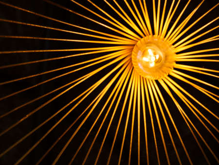 A close-up blur of a lamp made of wicker sticks