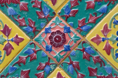 ancient ceramic tiles on the wall of wat, bangkok, thailandの写真素材