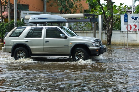 BANGKOK - NOVEMBER 7: Car navigating through the flood after the heaviest monsoon rain in 20 years in the capital  on November 7, 2011  Nuan Chan Road, bangkok, Thailand.のeditorial素材