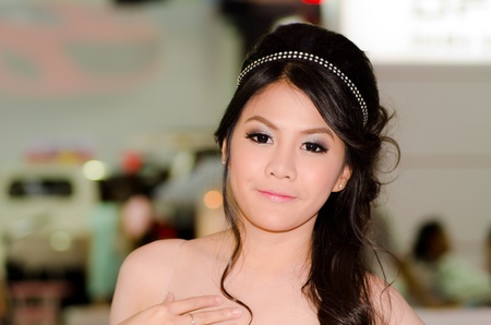 BANGKOK, THAILAND - DECEMBER 6: Unidentified female presenter at DFSK (Gong Feng) booth in THE 28th THAILAND INTERNATIONAL MOTOR EXPO 2011 on December 6, 2011 in Bangkok, Thailand.のeditorial素材