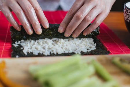 Female chef preparing sushi in the kitchenの写真素材