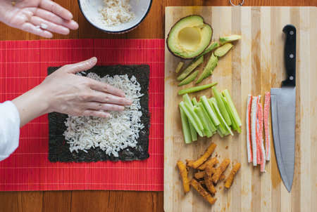 Female chef preparing sushi in the kitchenの写真素材