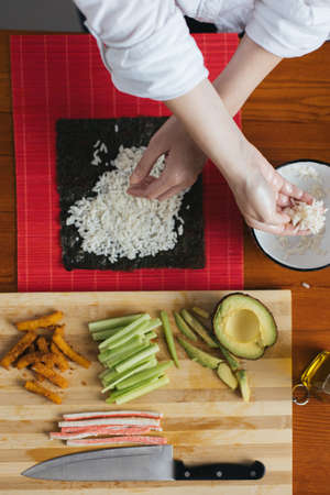 Female chef preparing sushi in the kitchenの写真素材