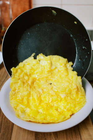 Preparing eggs for breakfast in home kitchen.