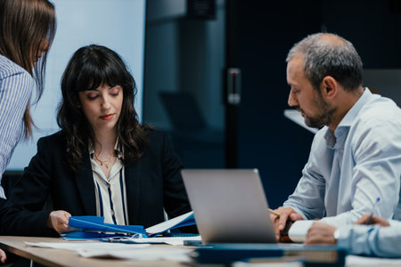 Executive business meeting with performance review on screen in office boardroomの写真素材