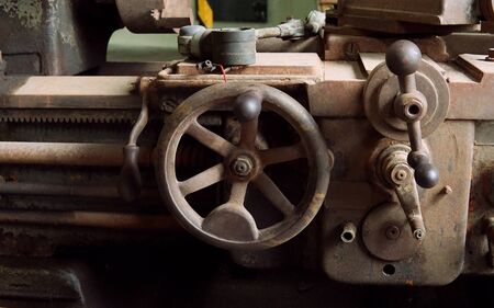 Image of old machine gear with several screw size. Broken and rustic machine left over in abandon...