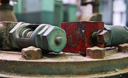 Image of old machine gear with several screw size. Broken and rustic machine left over in abandon factory. Image of aged equipment with rust and gear part.の写真素材