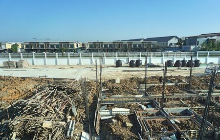 Piling work of home base with wood, concrete and equipment construction site background. Building construction concept.の写真素材