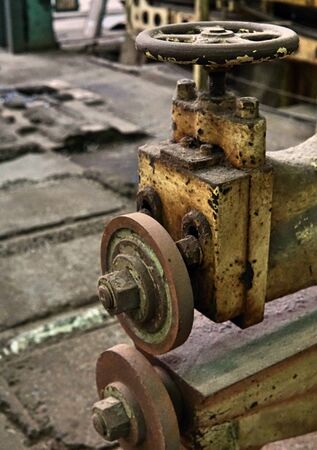 Grain Image: Close up of old machine factory made of steel and used in the past. Broken and rustic machine left over in abandon factory. Image of aged equipment with rust and gear part.の写真素材