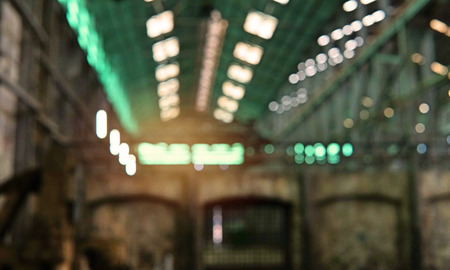Blur background inside of abandon factory. A structure interior of industry warehouse. An abandon old factory. Image of rustic factory room structure made from iron and steel.の写真素材