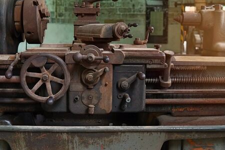 Grain Image: Close up of old machine factory made of steel and used in the past. Broken and rustic...