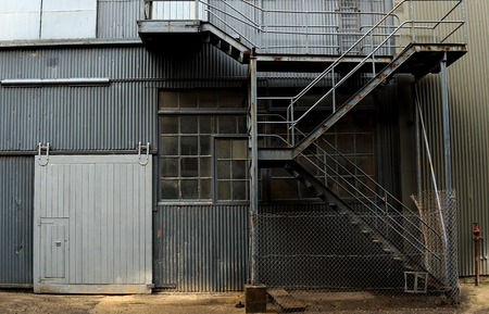 Inside of old abandon factory. A structure interior of industry warehouse. An abandon old factory with no equipment and machine. Image of rustic factory room structure made from iron and steel.の写真素材