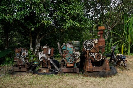 Grain Image: Close up of old machine factory made of steel and used in the past. Broken and rustic machine left over in abandon factory. Image of aged equipment with rust and gear part.の写真素材