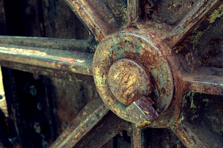 Grain Image: Close up of old machine factory made of steel and used in the past. Broken and rustic machine left over in abandon factory. Image of aged equipment with rust and gear part.の写真素材