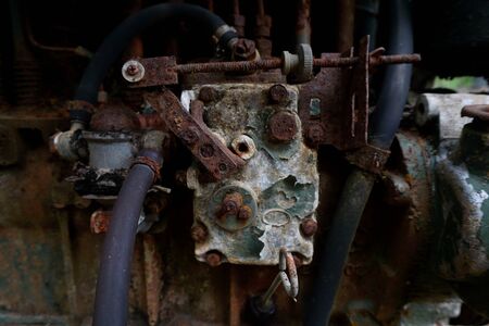 Grain Image: Close up of old machine factory made of steel and used in the past. Broken and rustic machine left over in abandon factory. Image of aged equipment with rust and gear part.の写真素材