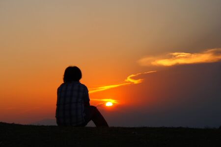 He is relax at the sunset  silhouette on mountian at Park  Nation in county of Thailand の写真素材