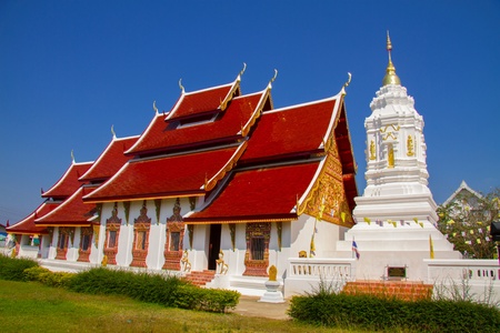 Red church and pagoda with blue sky at Wat Sree Bun Youn of Nan, Thailandの写真素材