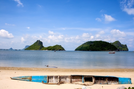 Small canoe broken on beach in the park seaside, Thailandの写真素材