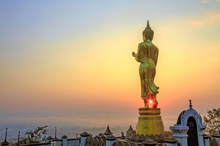 Golden at the sun shine sculpture Buddha with field at countryside of Nan, Thailandの写真素材