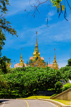 Flower and gold pagoda at Ban Glood Village, country of Thailandの写真素材