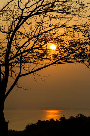 The sunset silhouette  at hill among lagoon in village of  Kanchanaburi Province Thailand  の写真素材