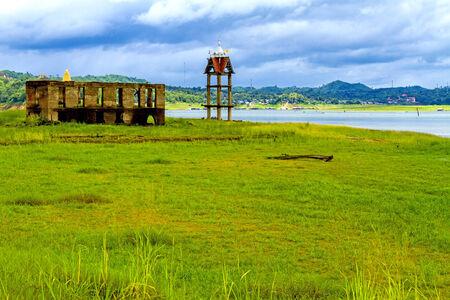 Green field and old belfry at sangklaburi, kanchanaburi, Province Asia thailandの写真素材