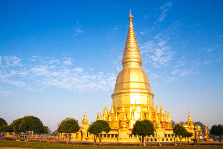 Sunshine morning golden pagoda at Wat  Phra That hau tom, Lamphun Province,Thailandの写真素材