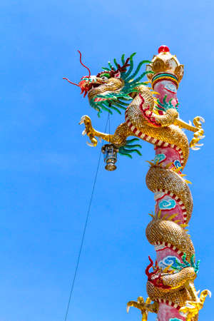 Statue dragon beautiful on pole with blue sky background in province, Thailandの写真素材