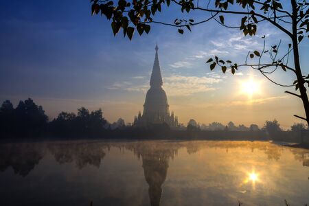 Sunrise with big pagoda golden at Wat  Phra That hau tom, Lamphun Province,Thailandの写真素材