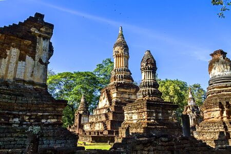 Wat Chedi Chet Thaeo temple and blue sky in Sisatchanalai Historical Park, Sukhothai province Thailandの写真素材